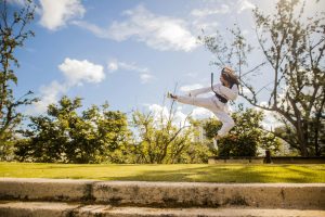 woman doing karate at a park
