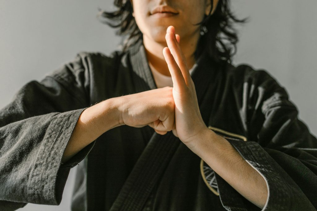 man in a gray robe practicing karate