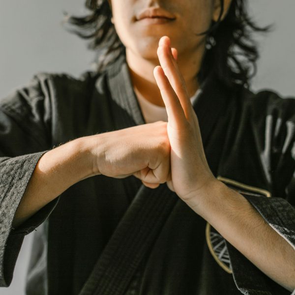 man in a gray robe practicing karate